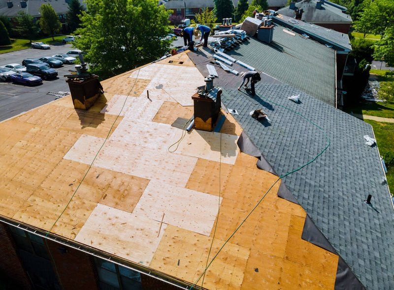 Full roof replacement in progress, with new architectural asphalt shingles being installed over fresh underlayment